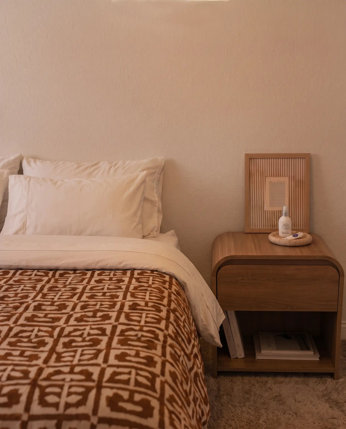 A bedroom at night under a harsh overhead light