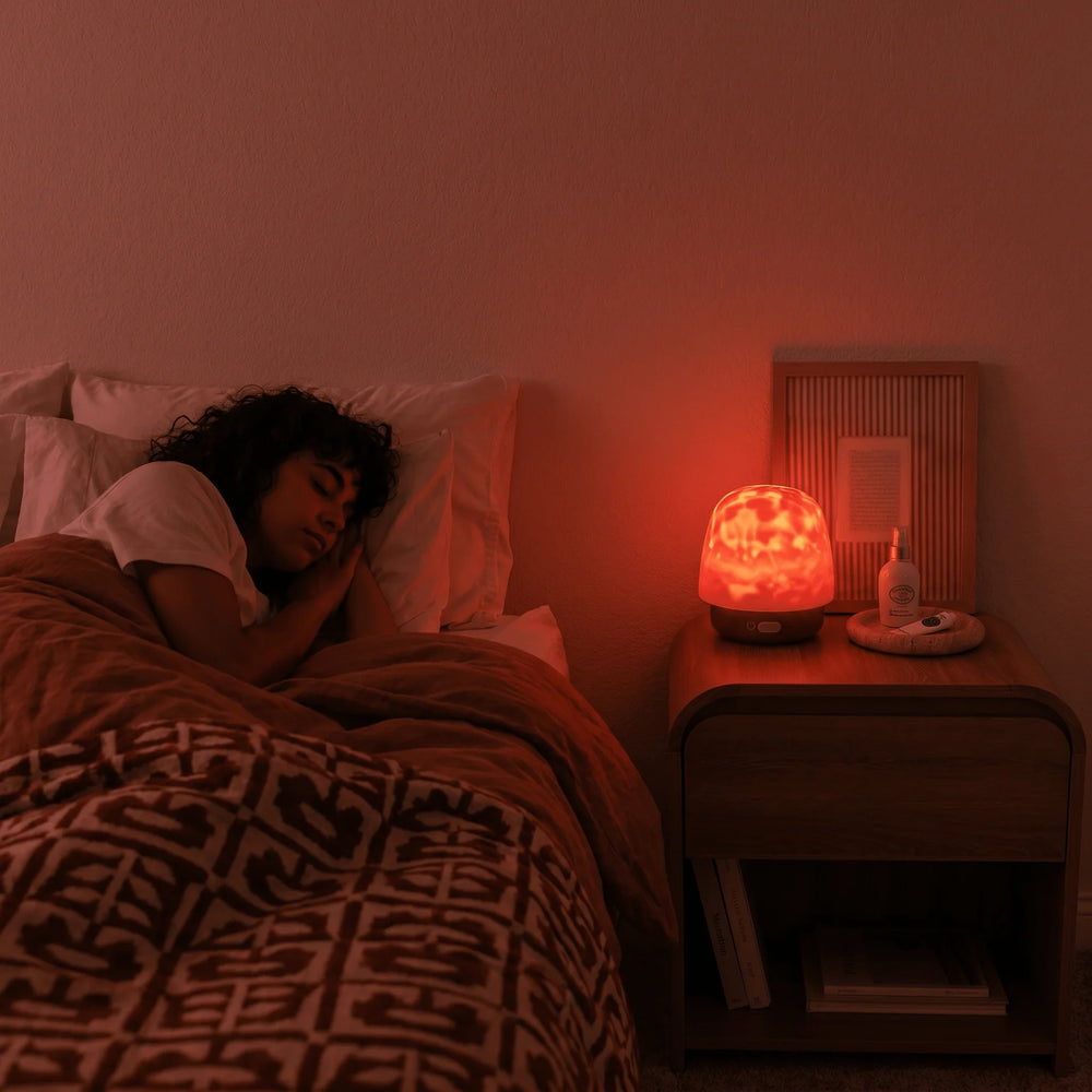 Hush Halo lamp casting warm ambient light beside a bed