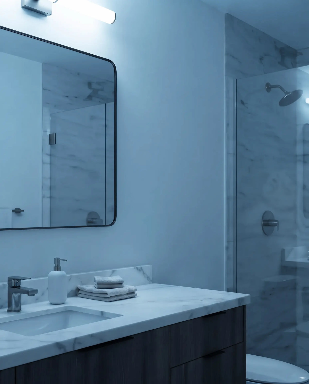 A bathroom under harsh cool overhead light