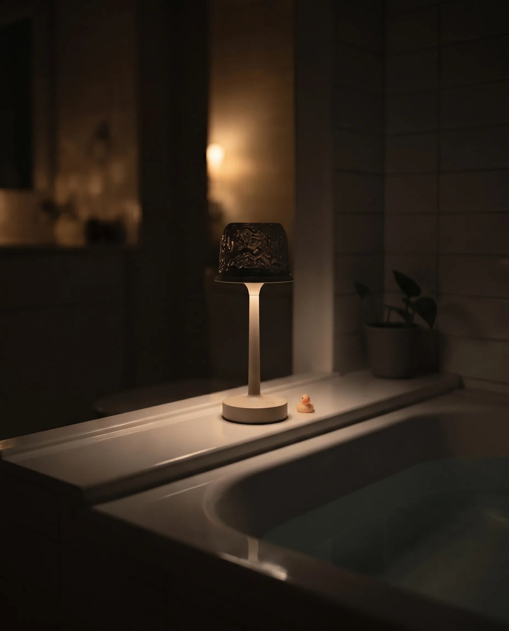 Hush Ember® lamp set on a tub ledge
