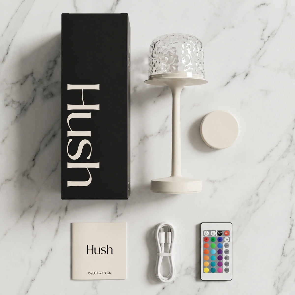Hush Ember with its USB-C cable and box on a dark surface